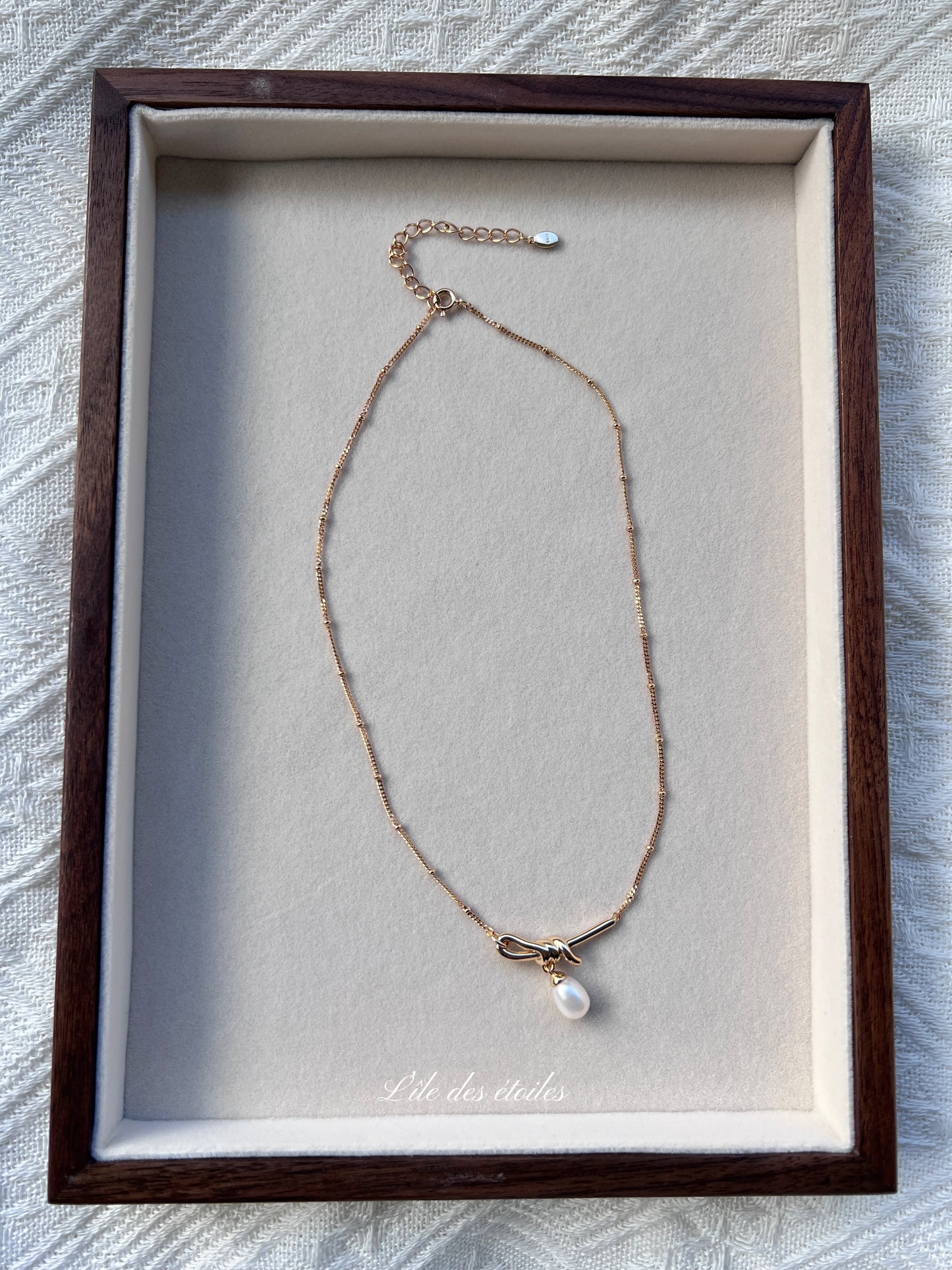 Collier en argent en forme de nœud avec perle