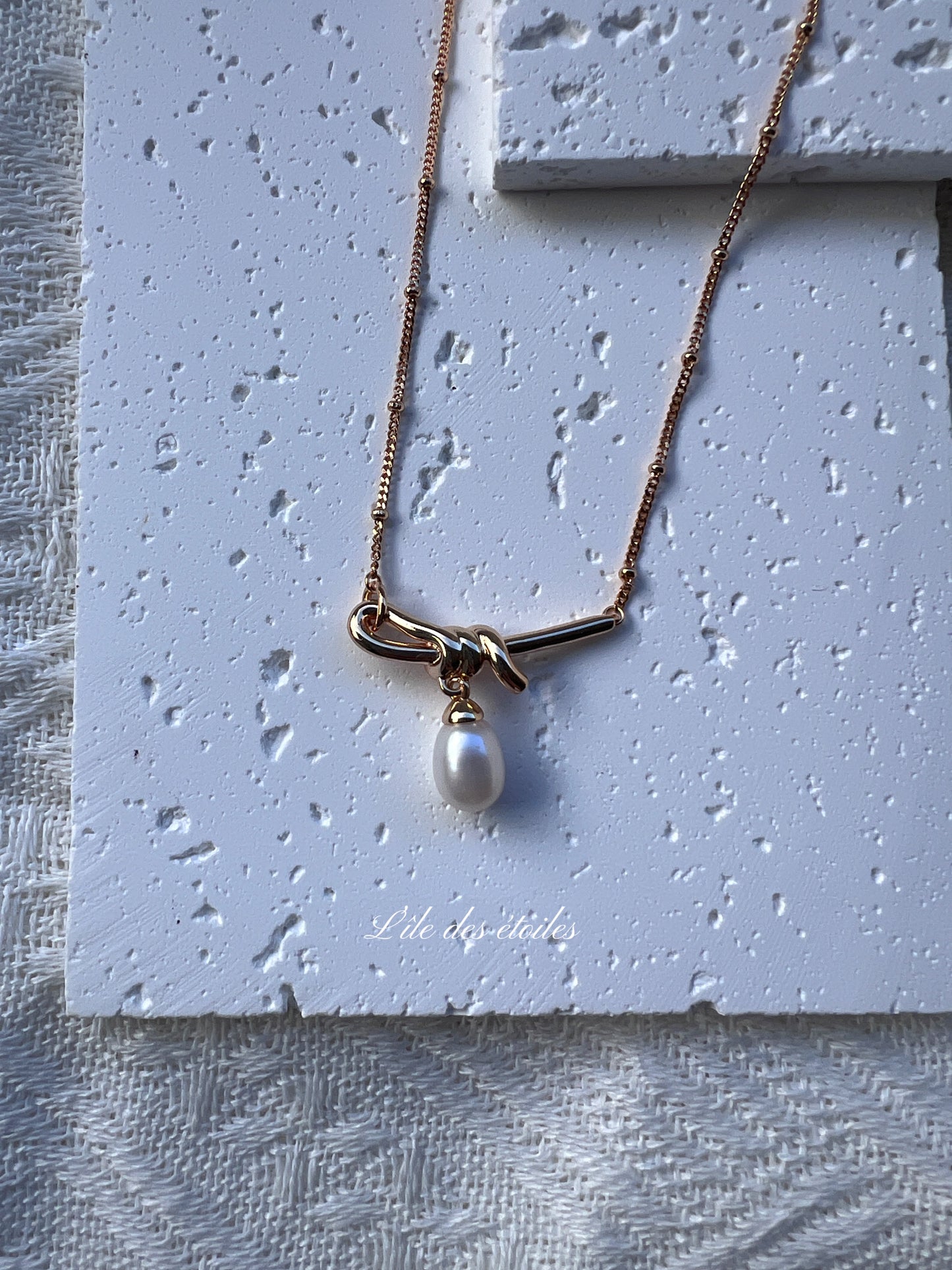 Collier en argent en forme de nœud avec perle